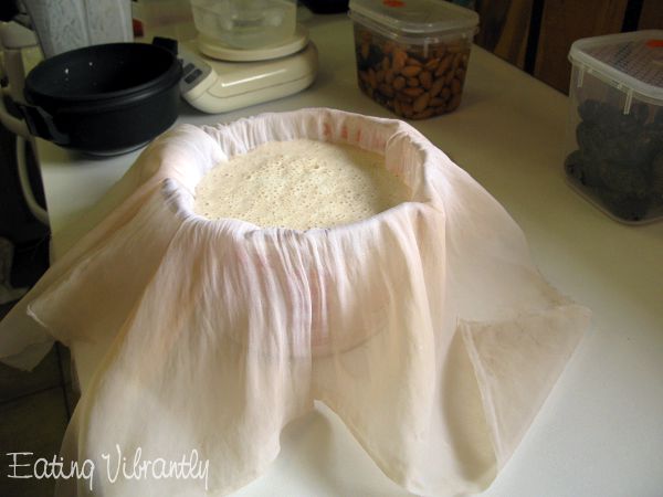 Raw vegan almond milk in jug with nut milk bag